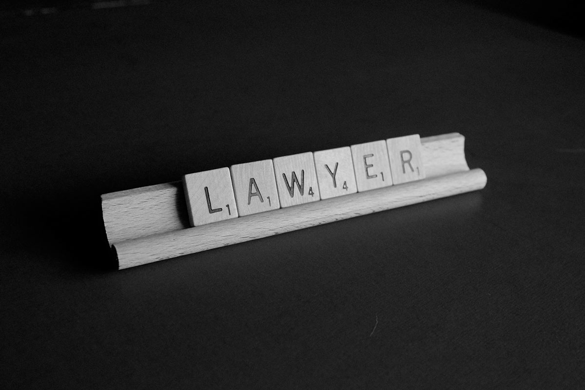 Scrabble tiles displaying the word lawyer
